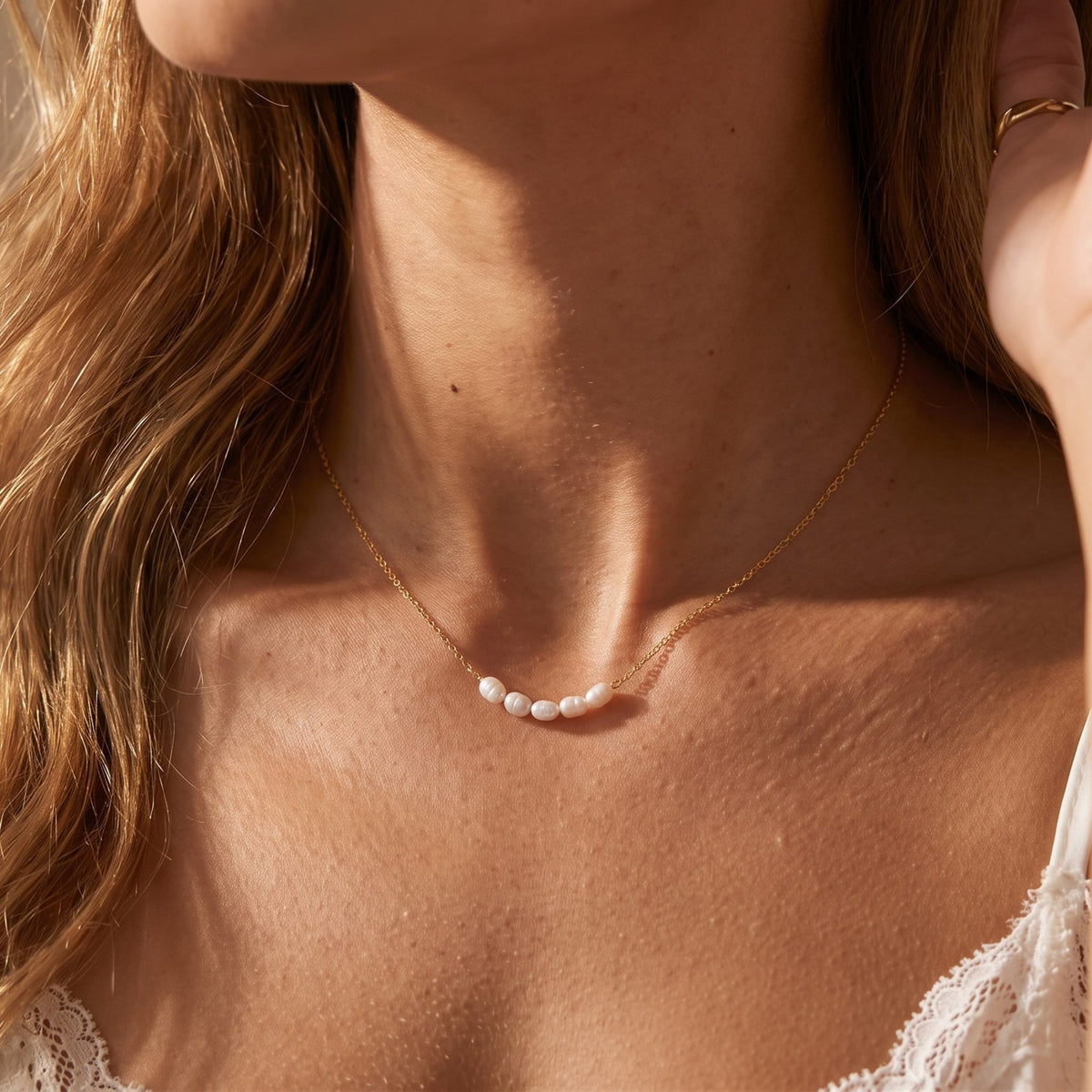 Close-up of the Pearl Bar Necklace worn on the neckline