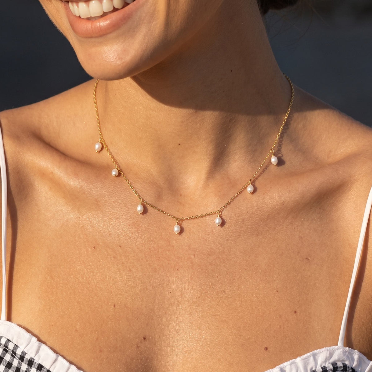 Close-up of the Pearl Fringe Necklace worn on the neckline