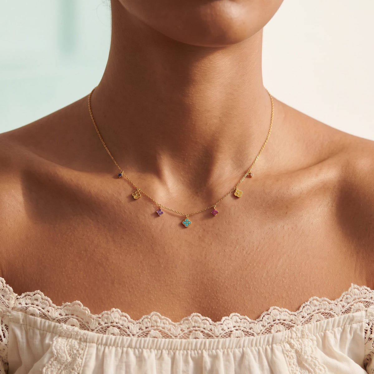 Wider view of a woman wearing the Prism Charm Necklace