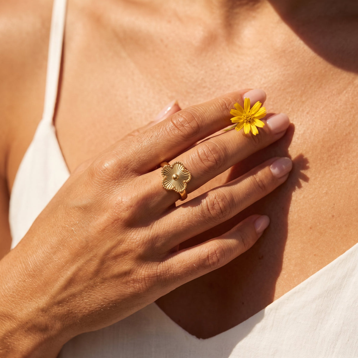 Wider view of a hand wearing the Quatrefoil Ring