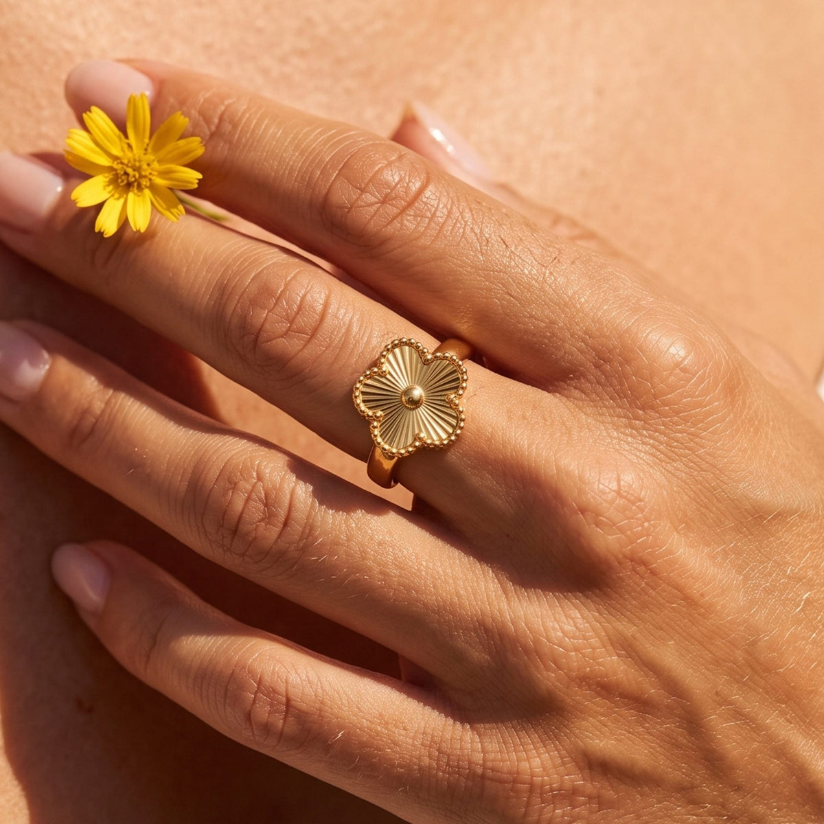 Close-up of the Quatrefoil Ring worn on the finger