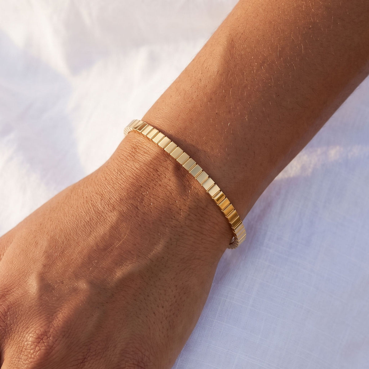 Ribbed Bangle worn on the wrist, photographed in natural daylight.