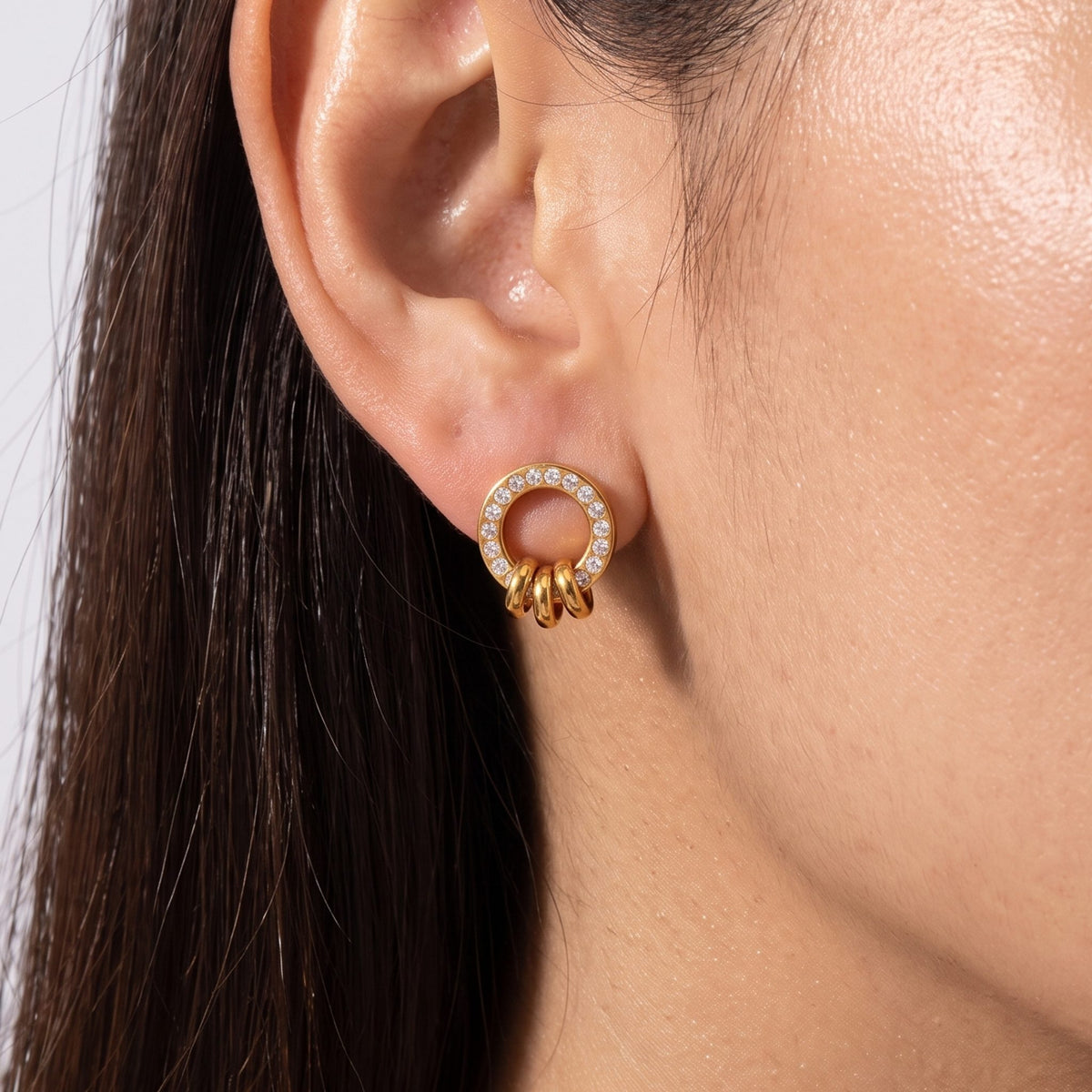 Close-up of the Ring Charm Studs on the ear showing crystal accents and small dangling rings
