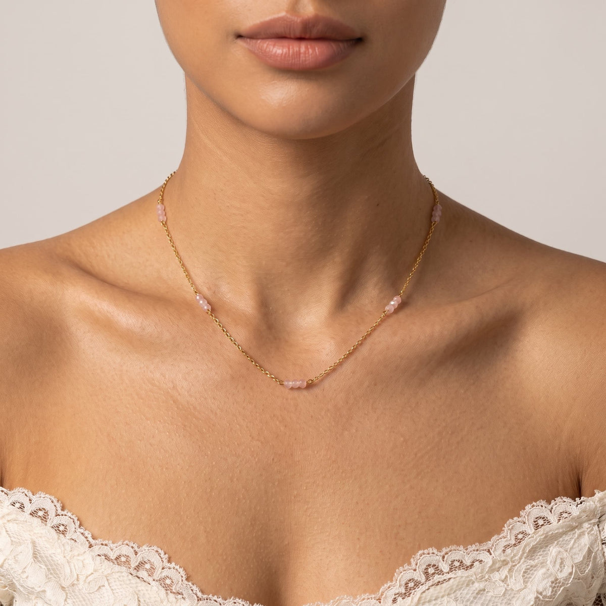 Wider view of a woman wearing the Rose Bead Necklace