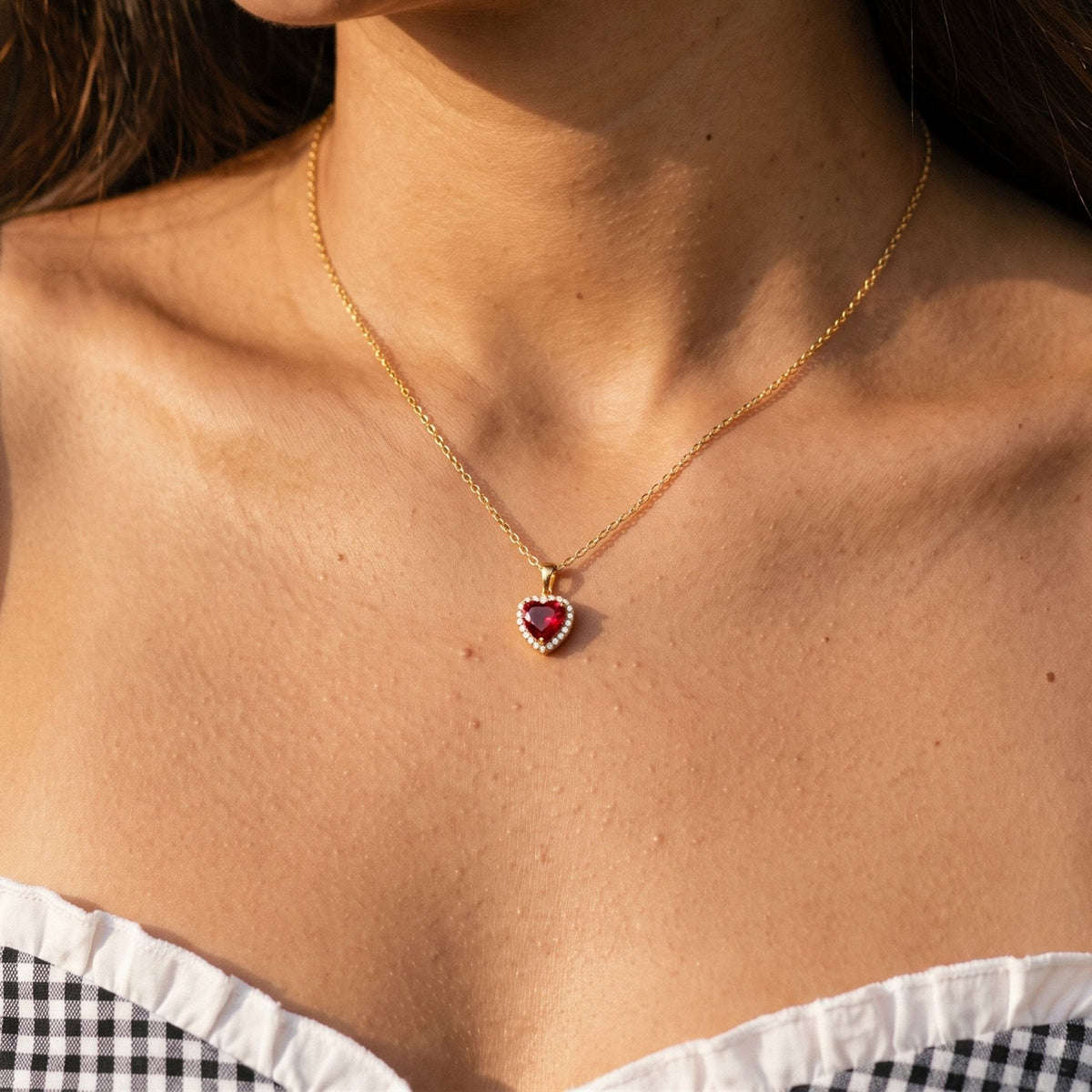 Close-up of the Ruby Heart Pendant worn on the neckline