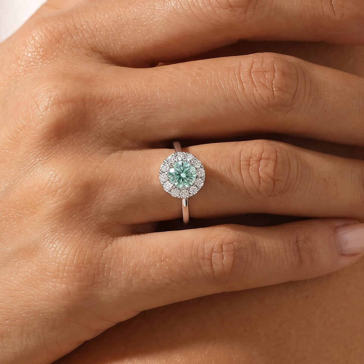 Close-up of the Seafoam Halo Ring worn on the finger
