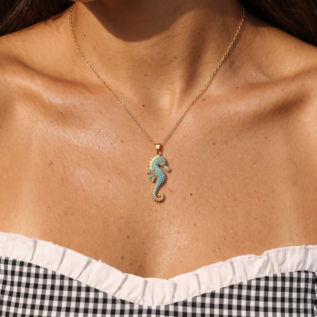 Close-up of the Seahorse Pendant worn on the neckline