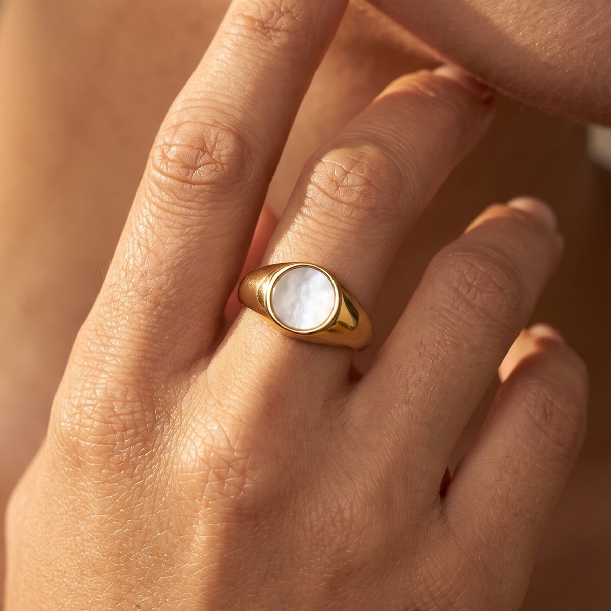 Close-up of the Shell Signet Ring worn on the finger