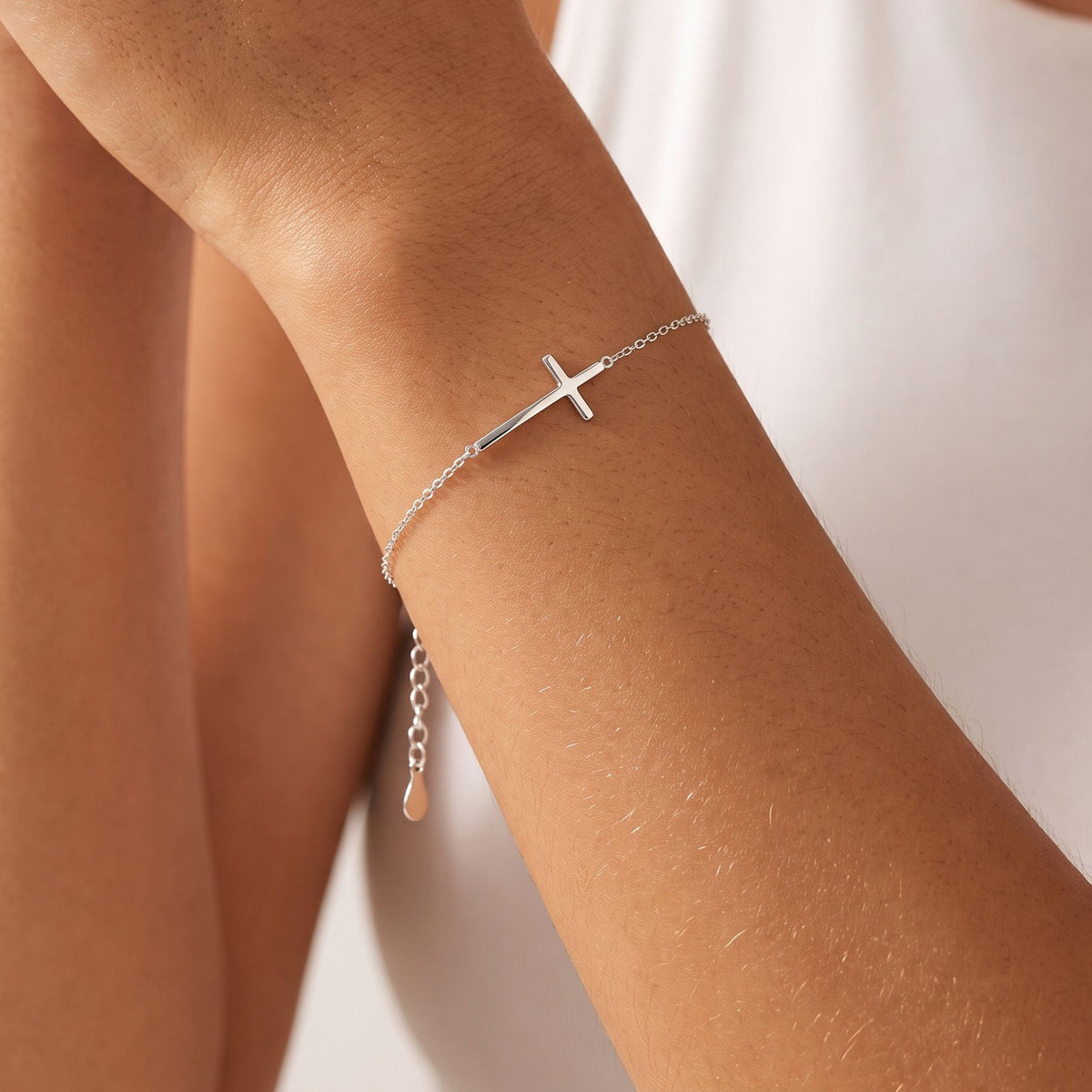 Sideways Cross Bracelet worn on the wrist, photographed in natural daylight.