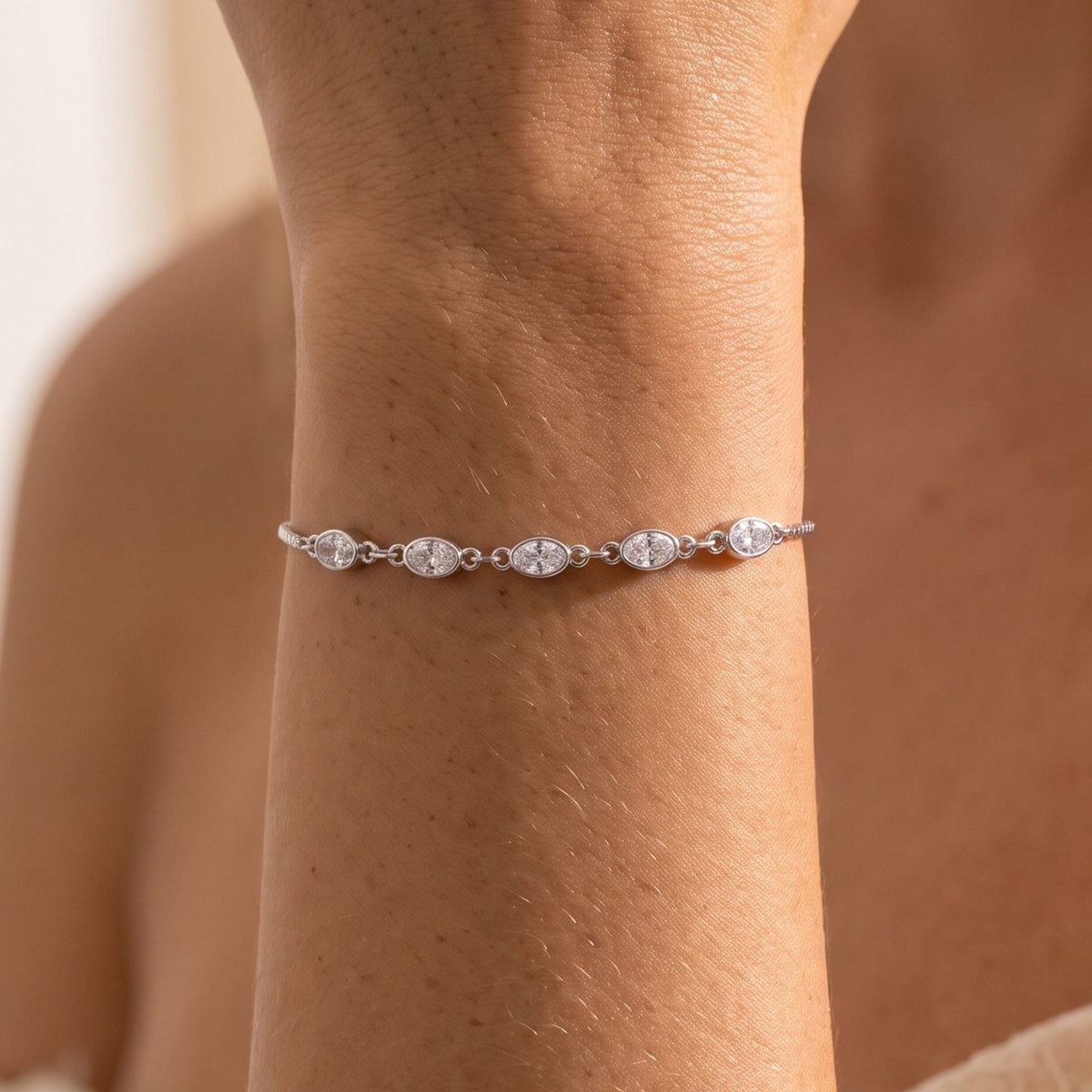 Close-up of the Silver Oval Bezel Bracelet on the wrist, highlighting the bezel-set oval crystals