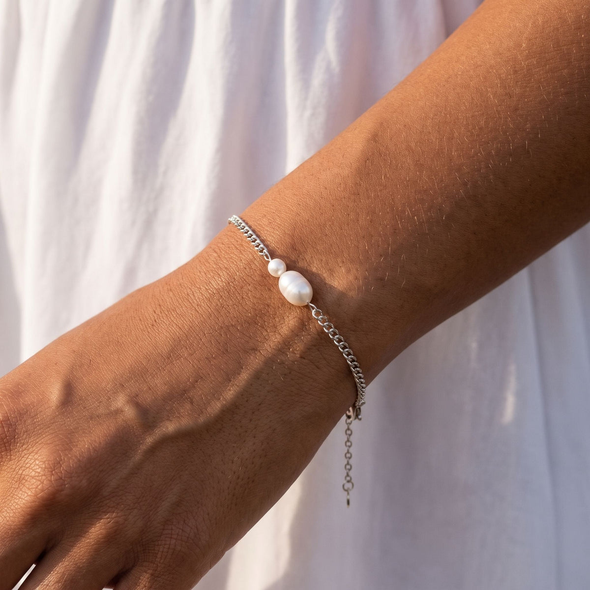 Silver Twin Pearl Bracelet worn on the wrist, photographed in natural daylight.