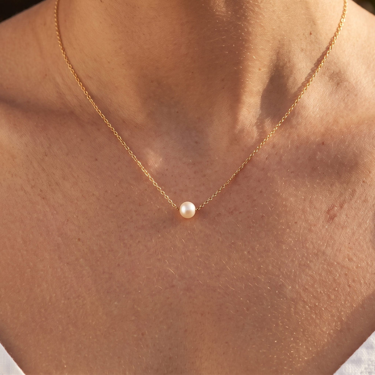 Close-up of the Single Pearl Pendant worn on the neckline