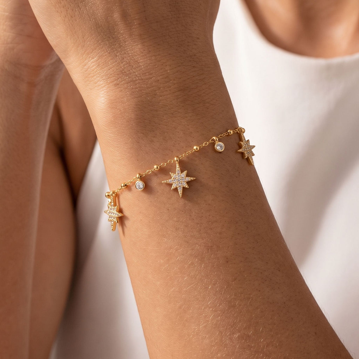 Star Charm Bracelet worn on the wrist, photographed in natural daylight.