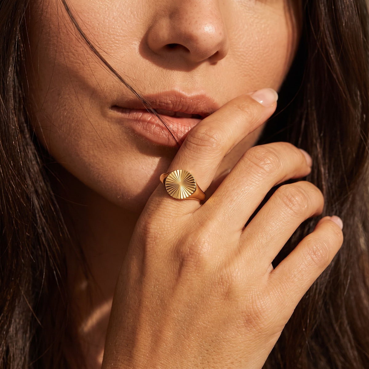 Wider view of a hand wearing the Sunray Signet Ring