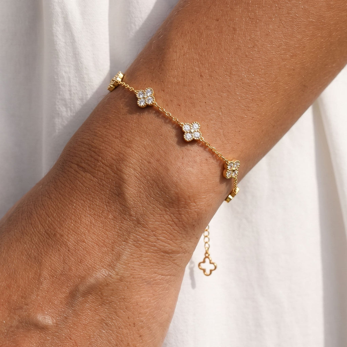 Trio Clover Bracelet worn on the wrist, photographed in natural daylight.