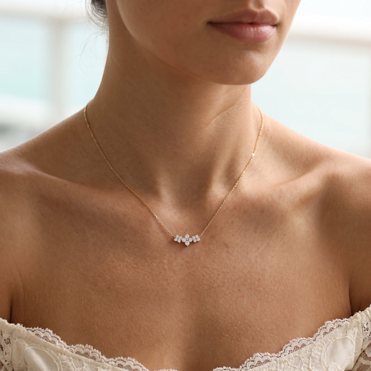 Wider view of a woman wearing the Triple Bloom Pendant