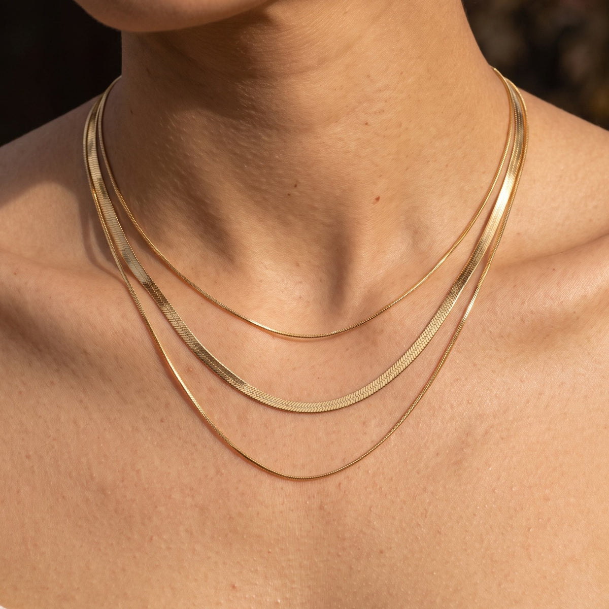 Close-up of the Triple Herringbone Necklace worn on the neckline