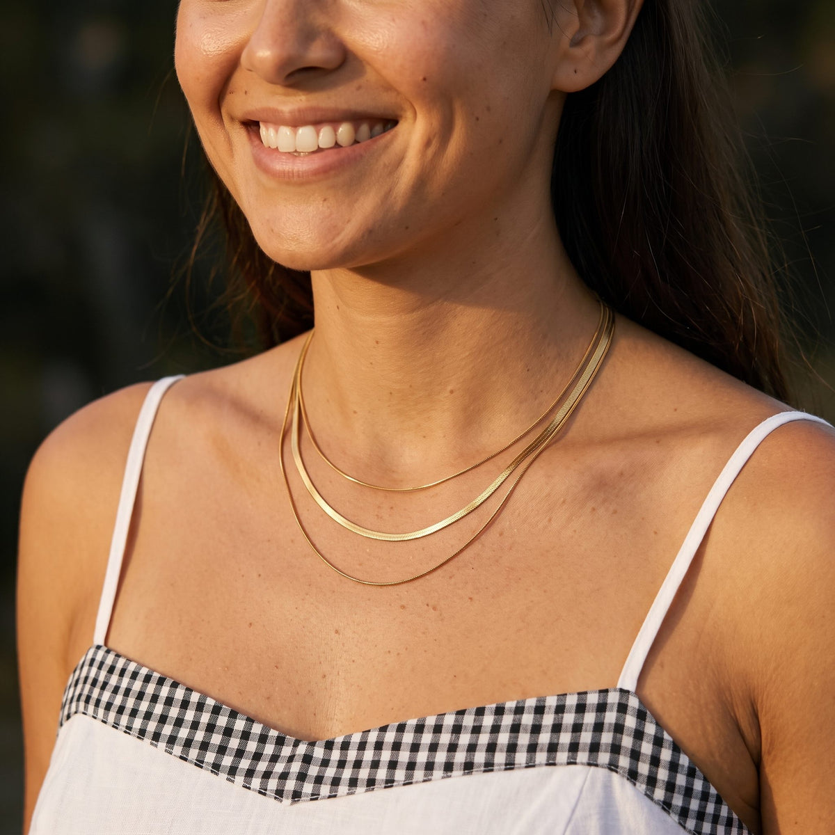 Wider view of a woman wearing the Triple Layer Necklace