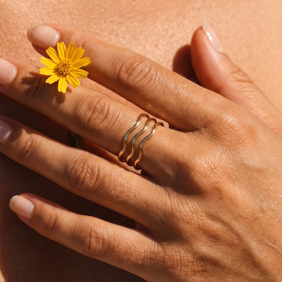 Close-up of the Triple Wave Ring worn on the finger