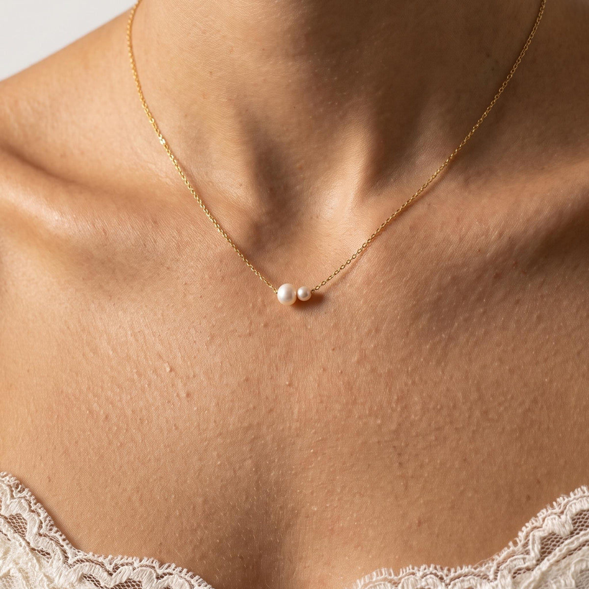 Close-up of the Twin Pearl Pendant worn on the neckline