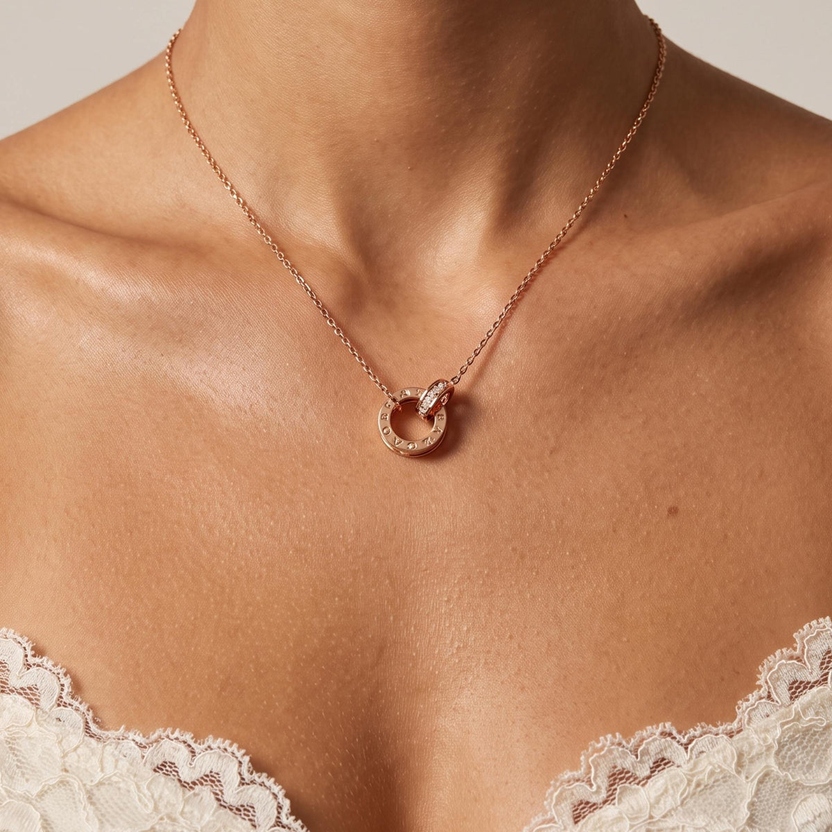 Close-up of the Twin Ring Pendant worn on the neckline