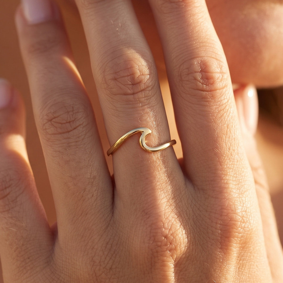 Close-up of the Wave Crest Ring worn on the finger