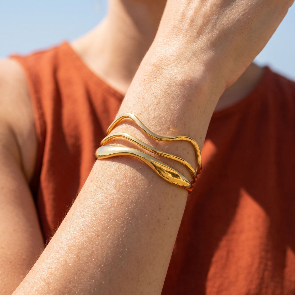 Wave Wrap Cuff worn on the wrist, showing the open ends of the cuff.