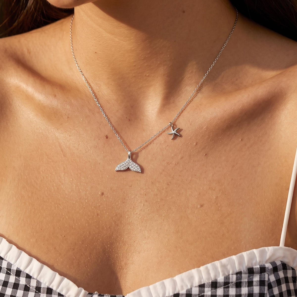 Close-up of the Whale & Starfish Necklace worn on the neckline