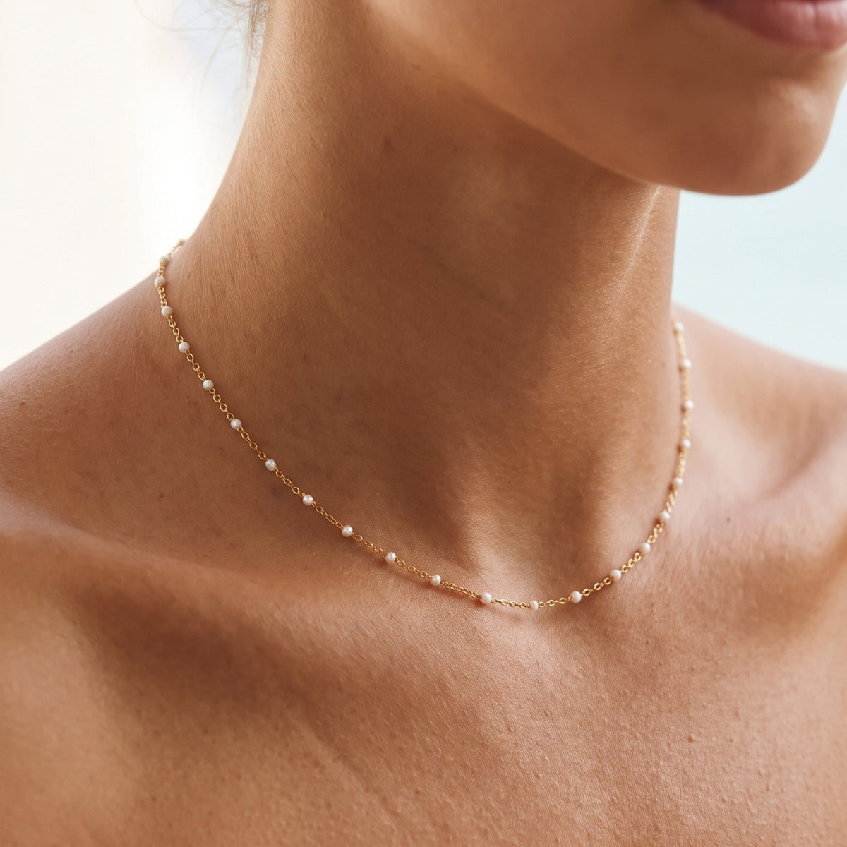 Close-up of the White Bead Necklace worn on the neckline