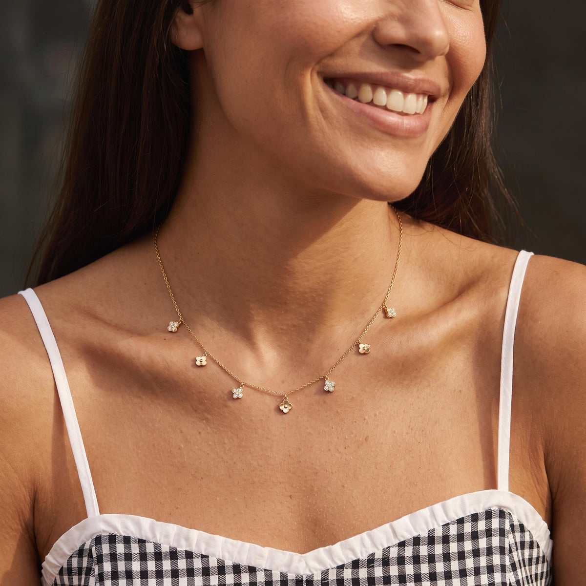 Wider view of a woman wearing the Alternating Clover Necklace