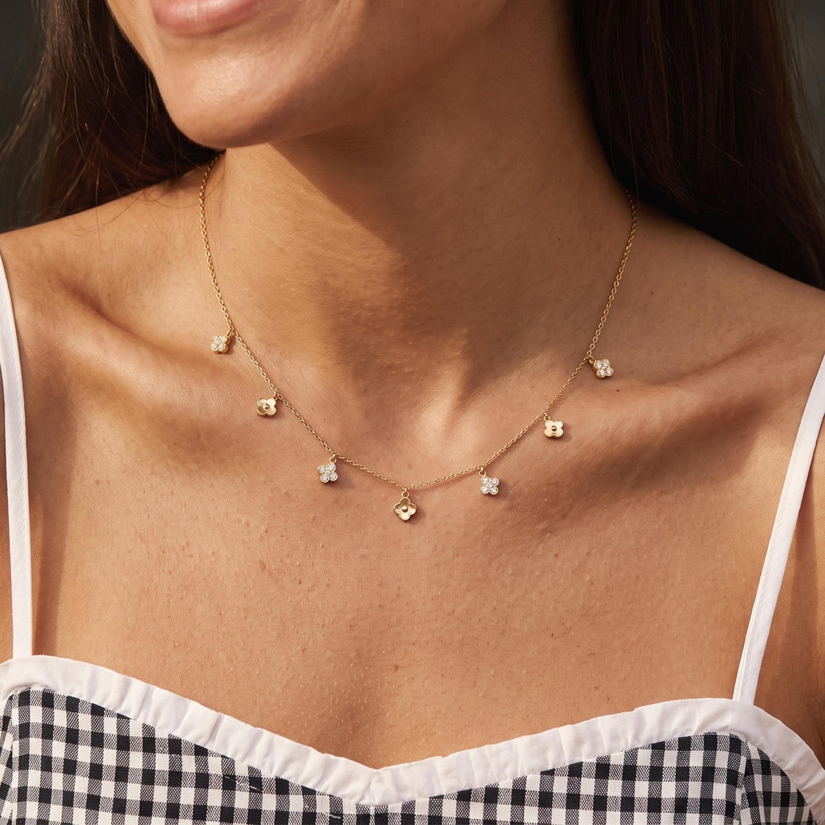 Close-up of the Alternating Clover Necklace worn on the neckline