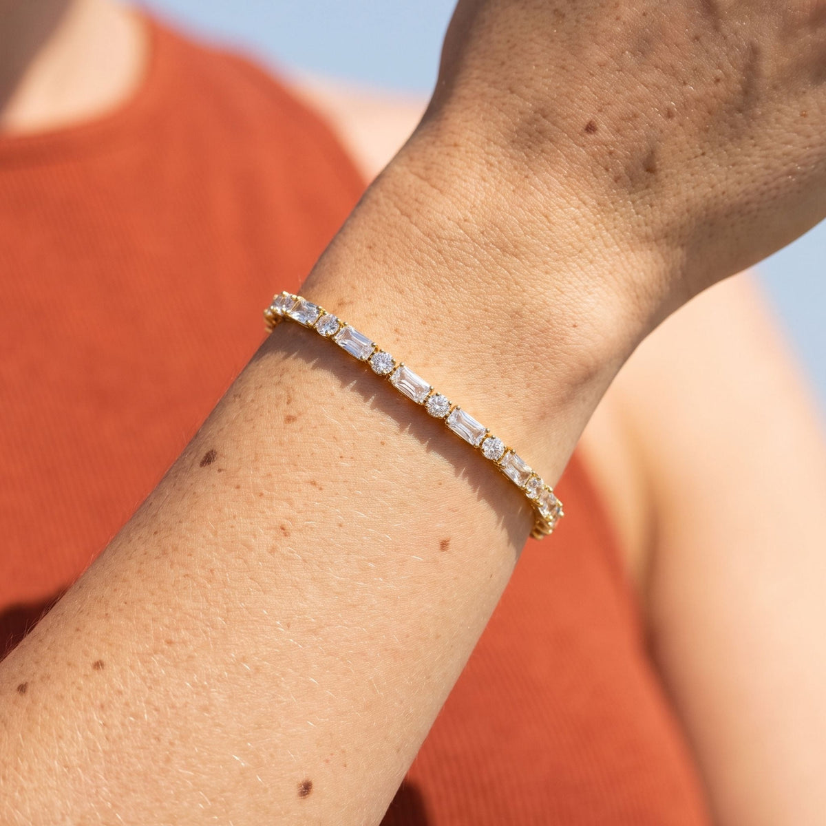 Baguette Tennis Bracelet worn on the wrist, photographed in natural daylight.