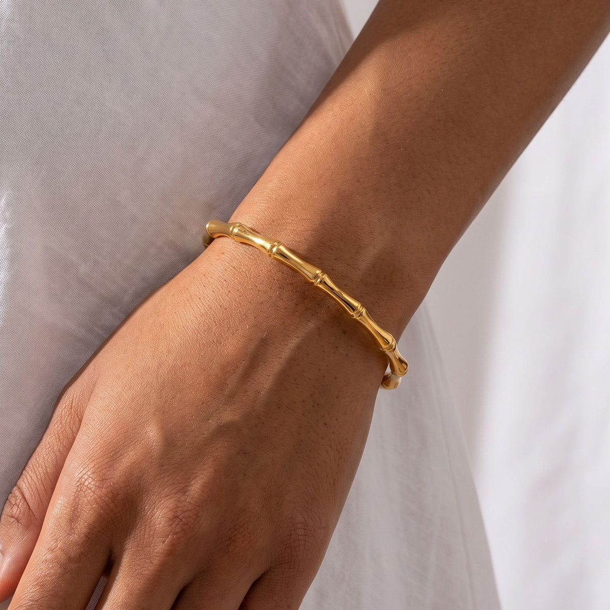 Bamboo Bangle worn on the wrist, photographed in natural daylight.
