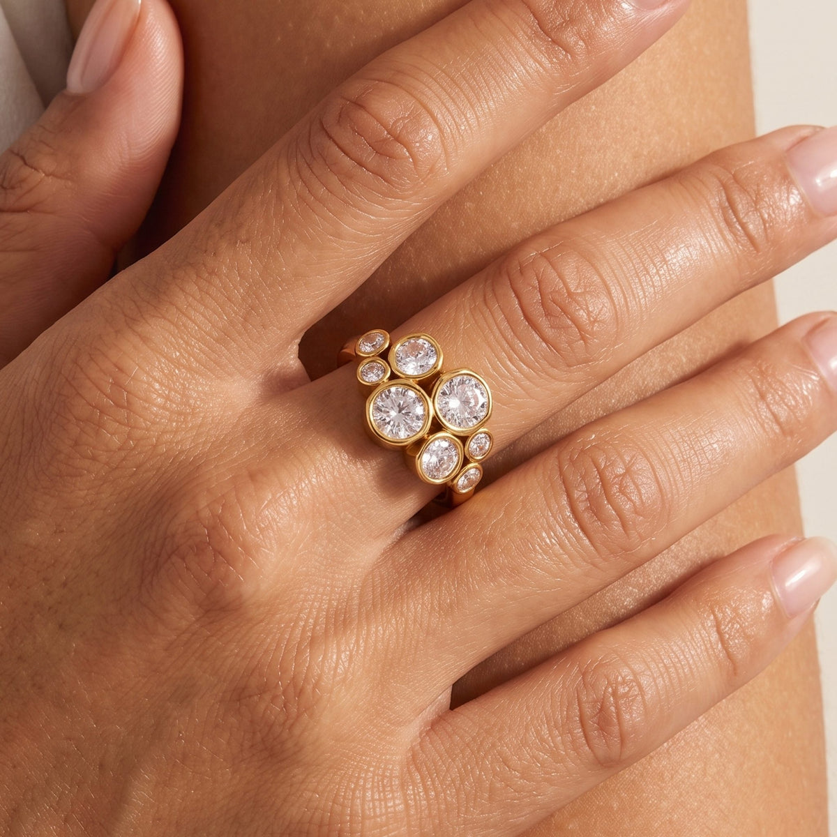 Close-up of the Bezel Cluster Ring worn on a ring finger featuring sparkling crystals in bezel settings