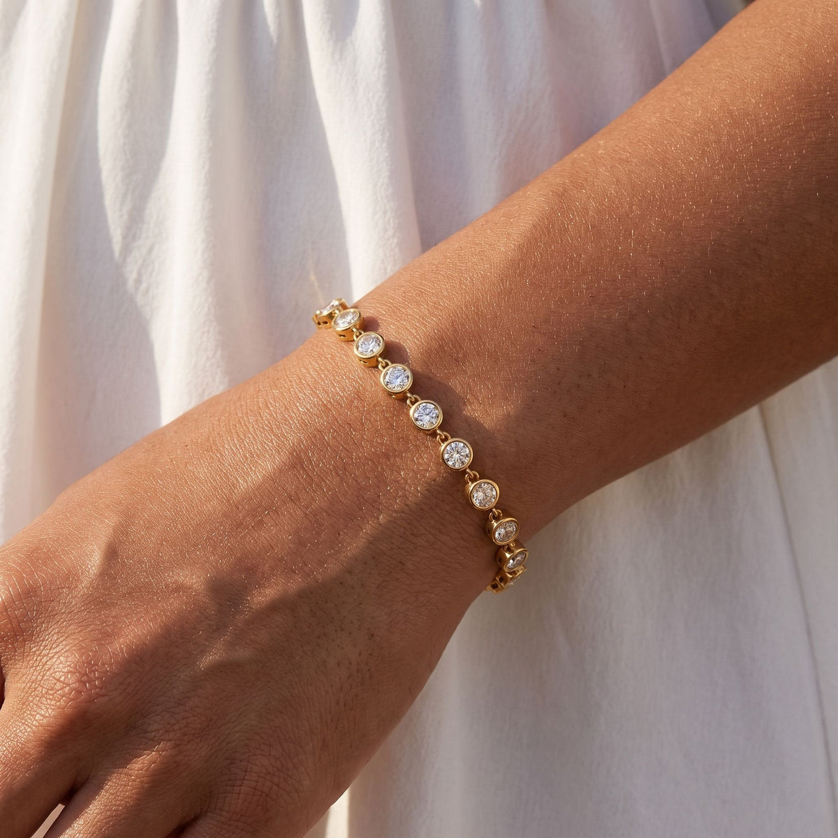 Bezel Tennis Bracelet worn on the wrist, photographed in natural daylight.