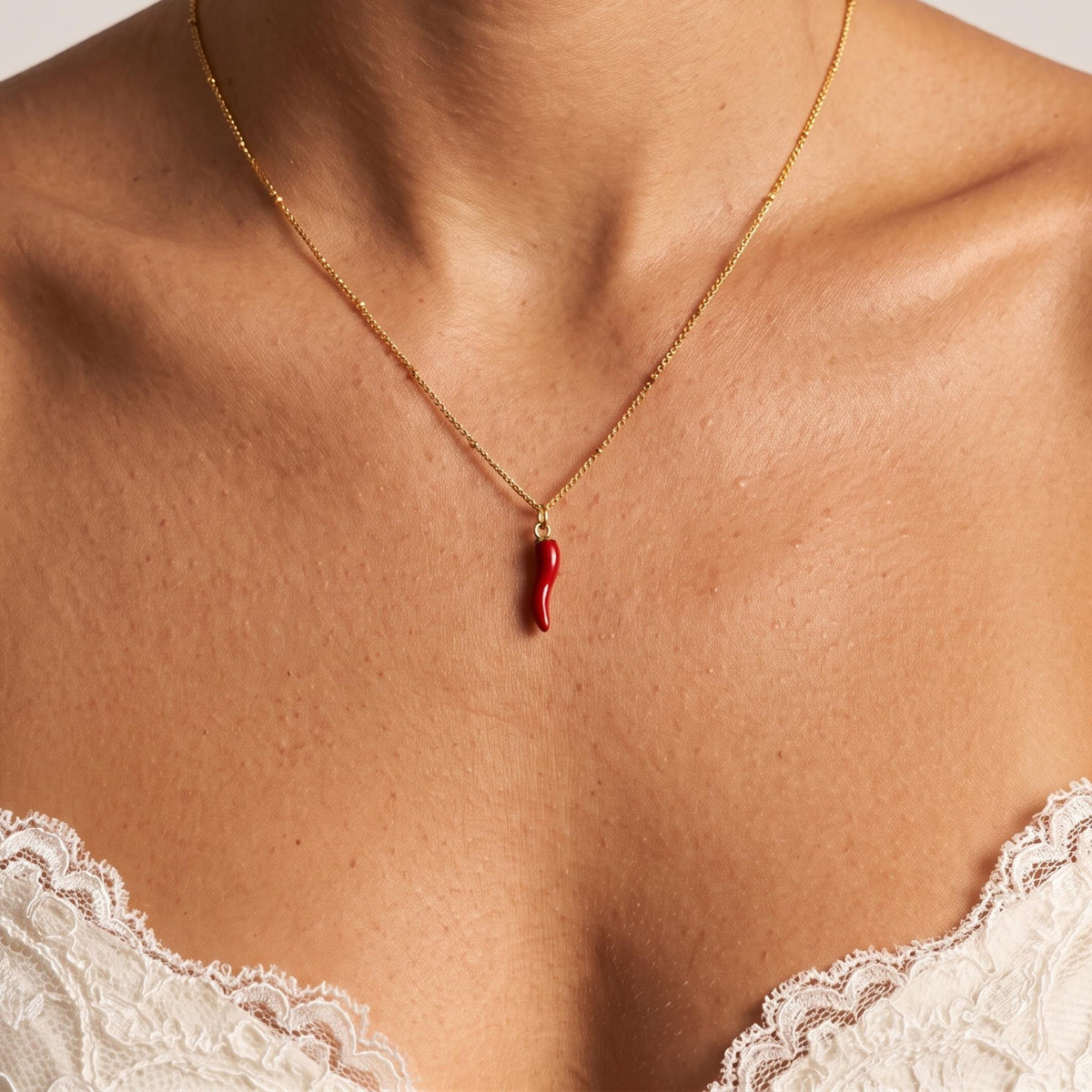 Close-up of the Chilli Pendant worn on the neckline