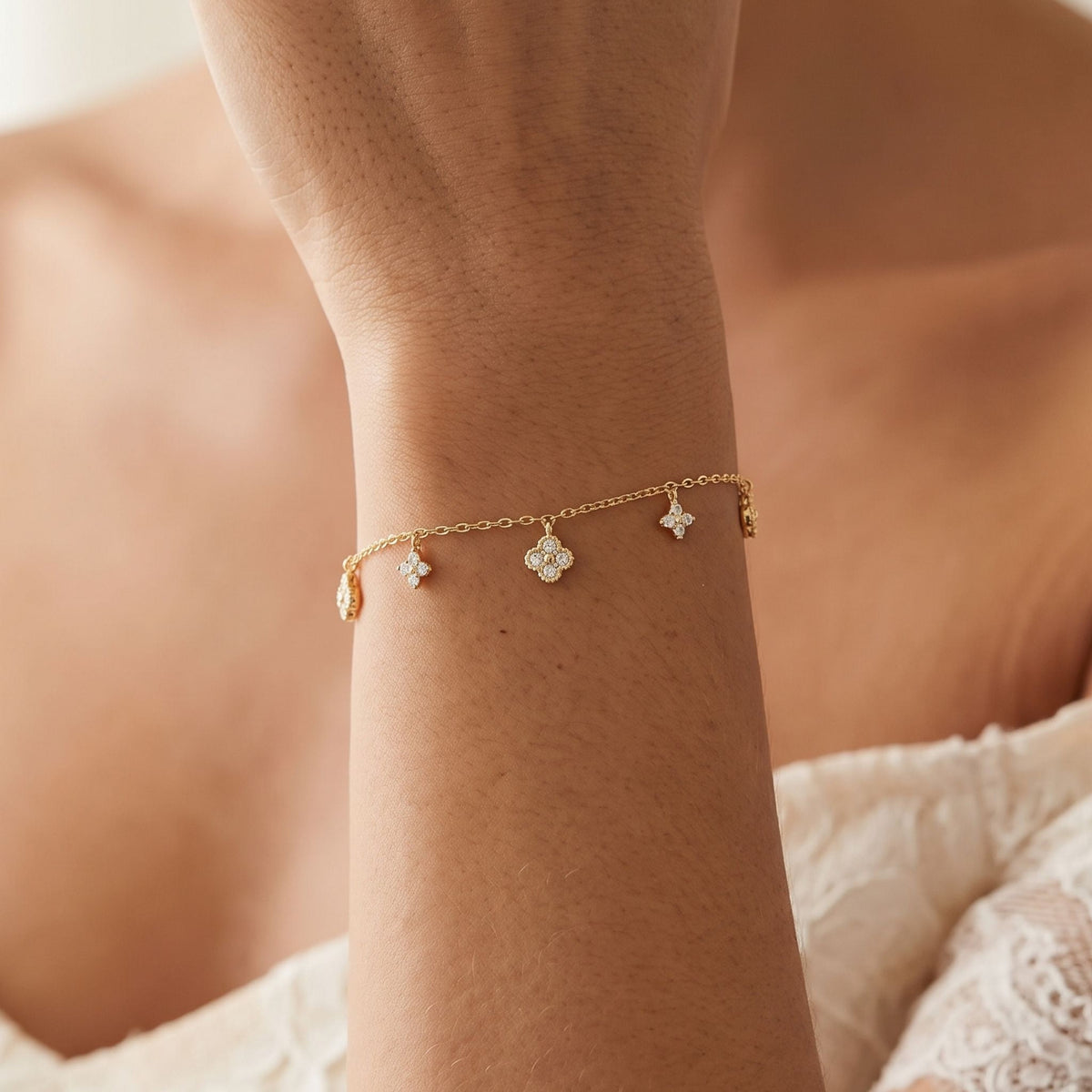 Clover Charm Bracelet worn on the wrist, photographed in natural daylight.