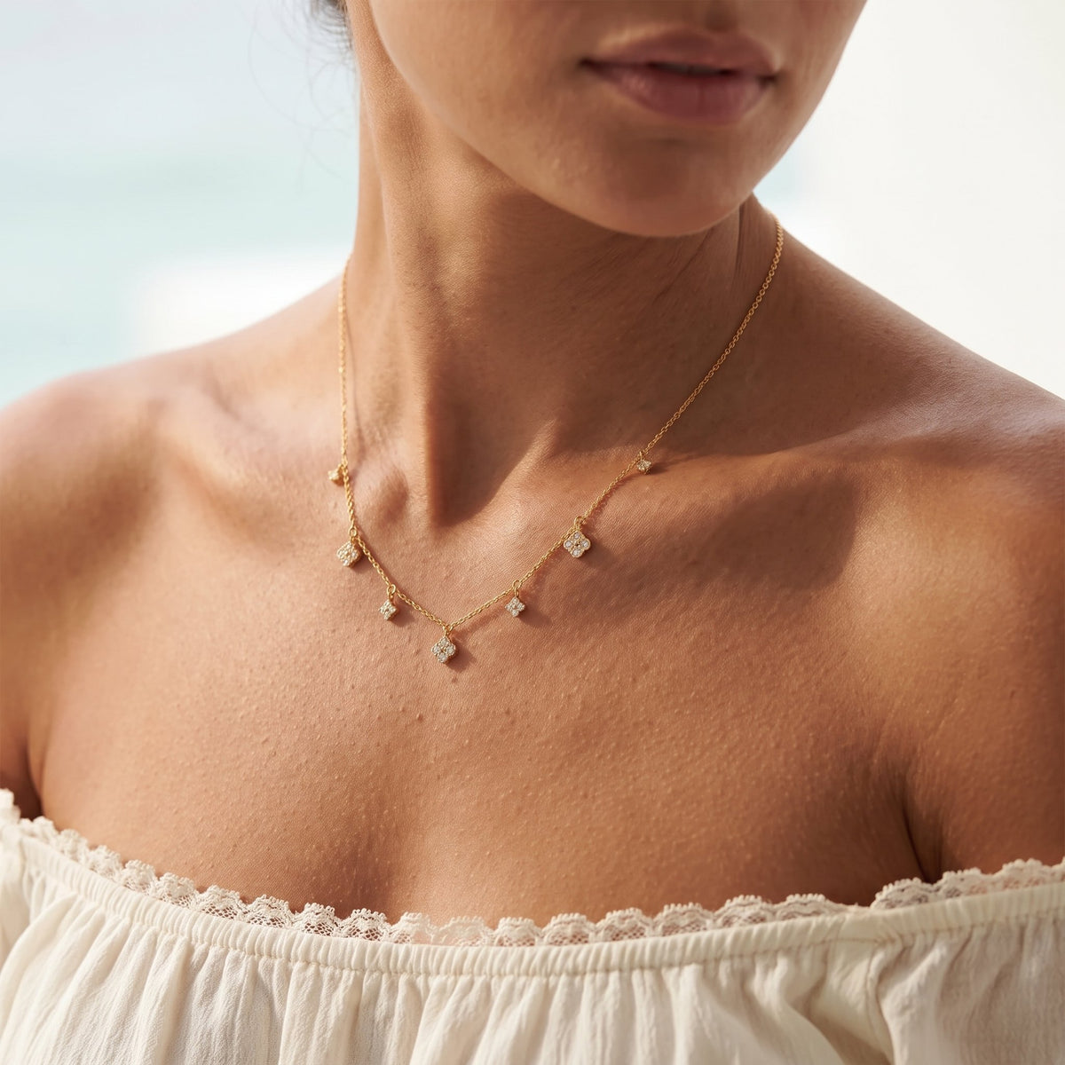 Wider view of a woman wearing the Clover Charm Necklace