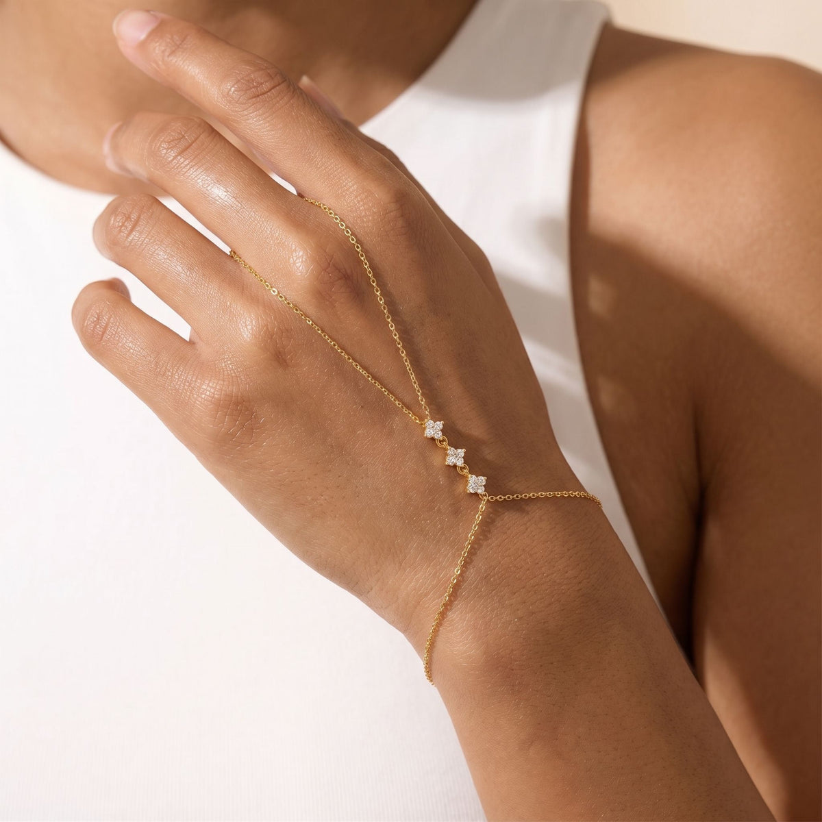 Cluster Hand Chain worn across the back of the hand, with the ring on the finger and the chain at the wrist.