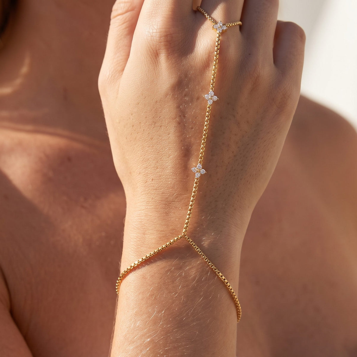 Close-up of the Crystal Clover Hand Chain on the wrist and hand, showcasing its sparkling crystal clovers