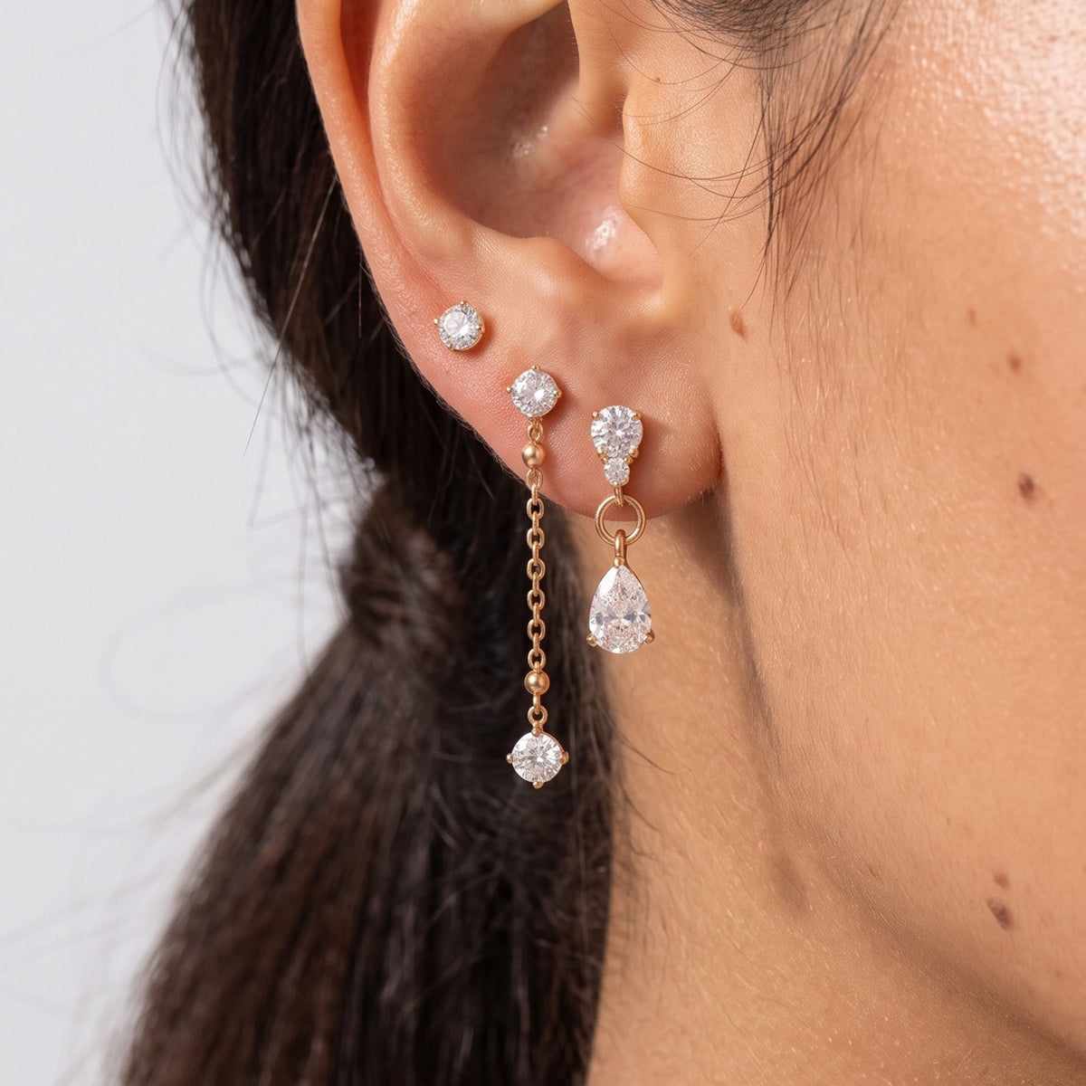 Close-up of the Crystal Ear Set on the ear, featuring delicate gold chains and crystal drops