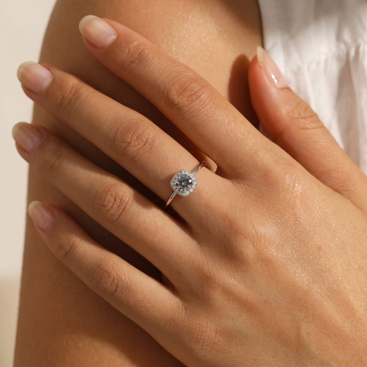 Wider view of a hand wearing the Cushion Halo Ring