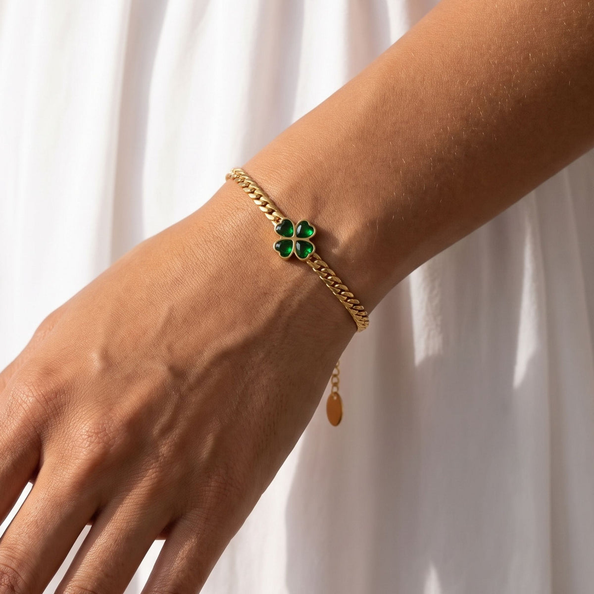 Emerald Clover Bracelet worn on the wrist, photographed in natural daylight.