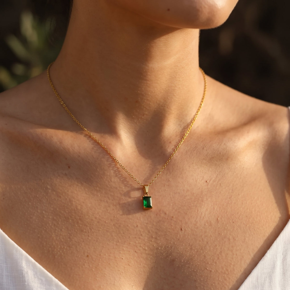 Wider view of a woman wearing the Emerald Cut Pendant