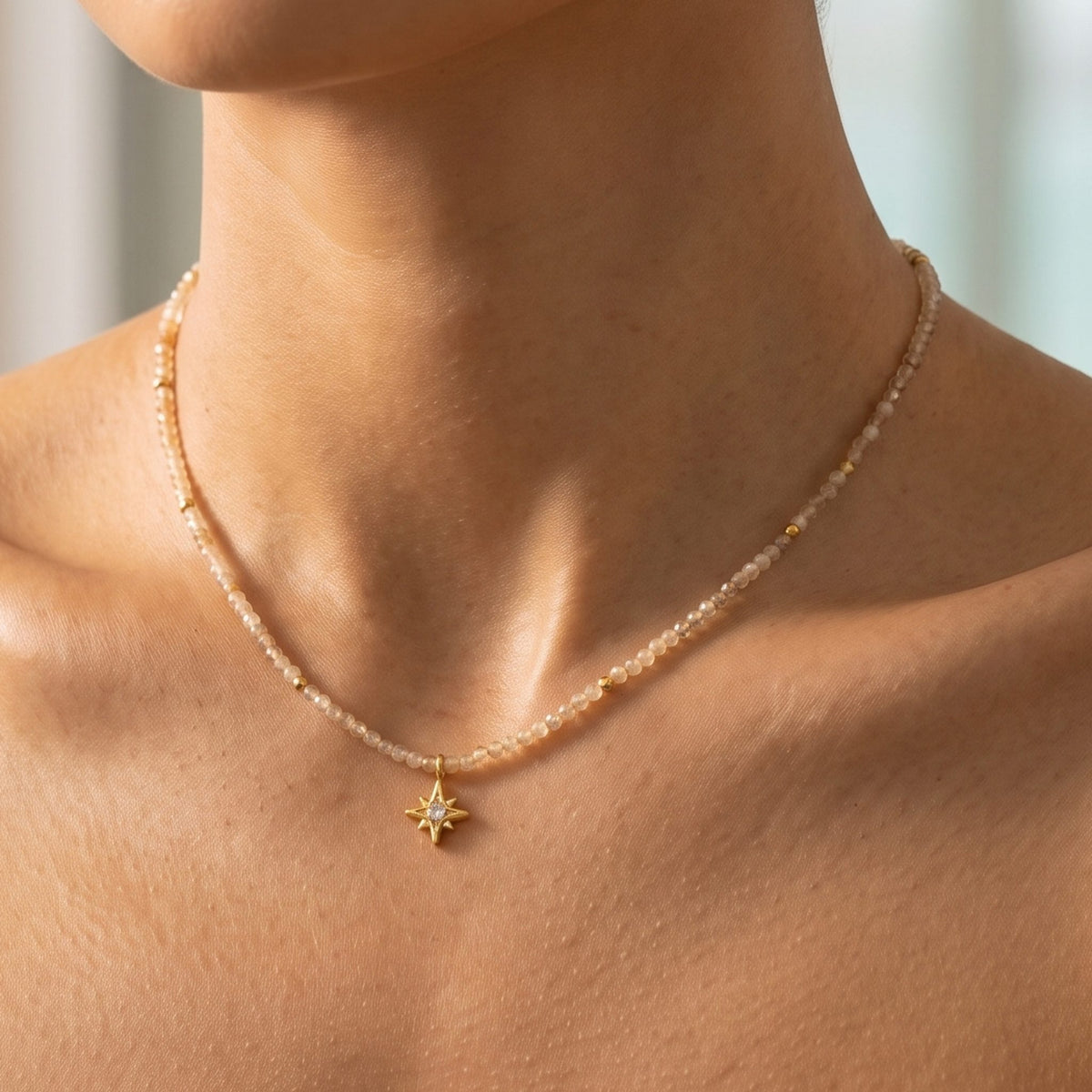 Close-up of the Faceted Bead Necklace at the collarbone showing its gold star charm
