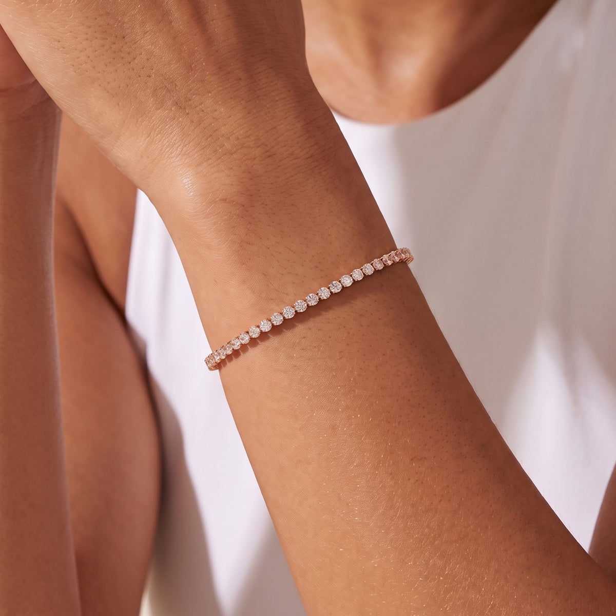 Fine Tennis Bracelet in rose gold worn on the wrist, photographed in natural daylight