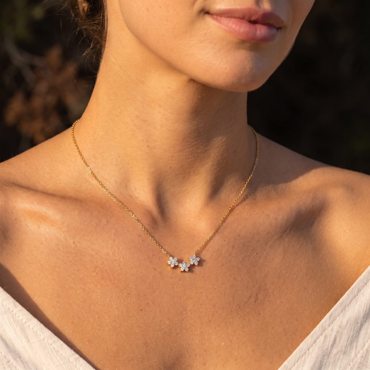 Wider view of a woman wearing the Flower Cluster Pendant