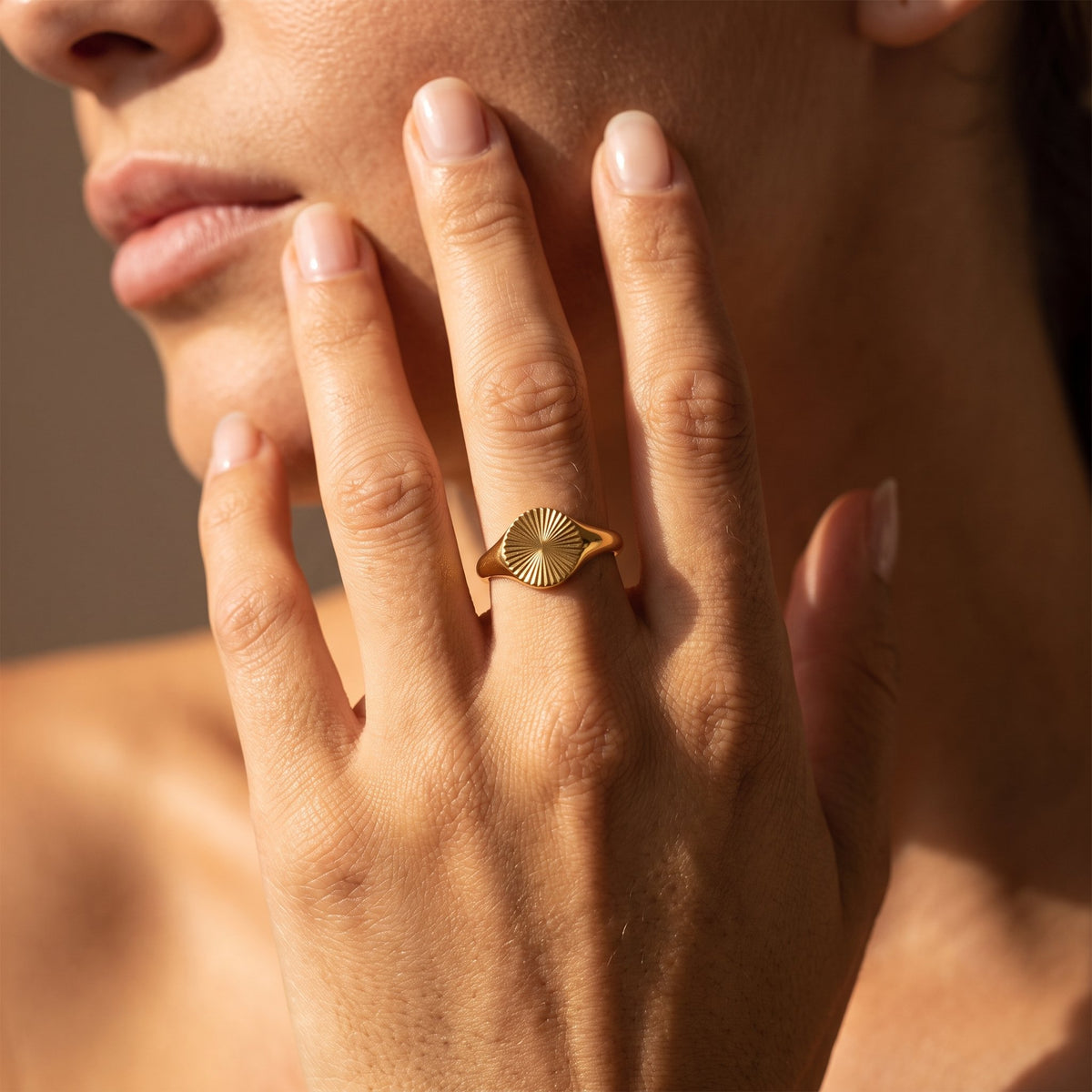 Wider view of a hand wearing the Fluted Signet Ring