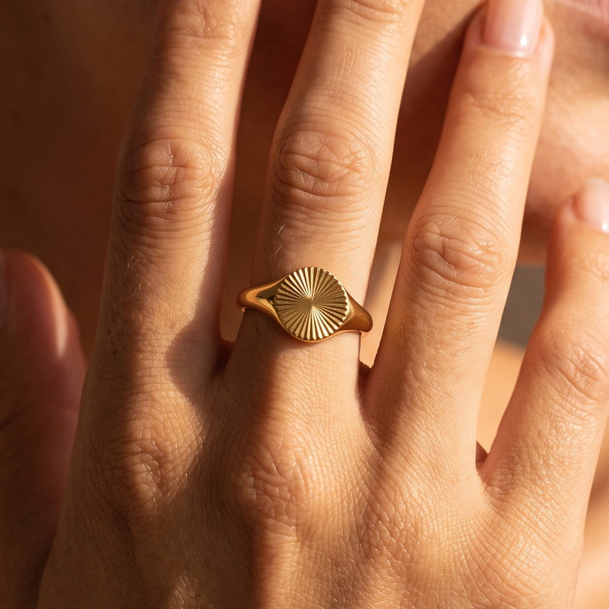 Close-up of the Fluted Signet Ring worn on the finger