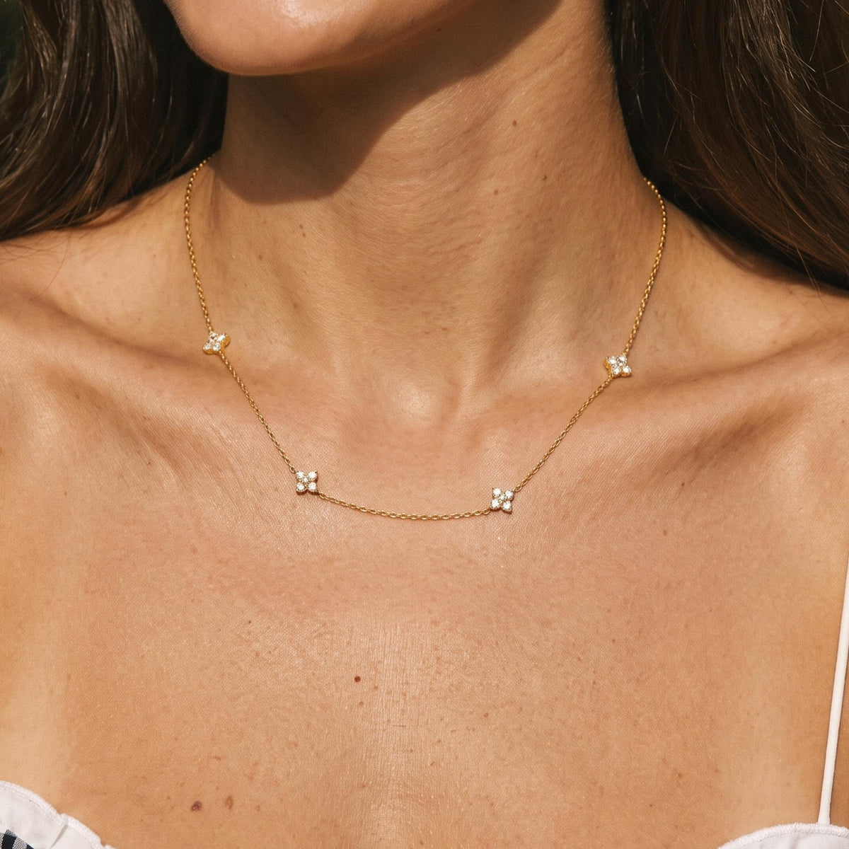 Close-up of the Four Bloom Necklace worn on the neckline